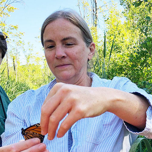 Professor holding a monarch butterfly